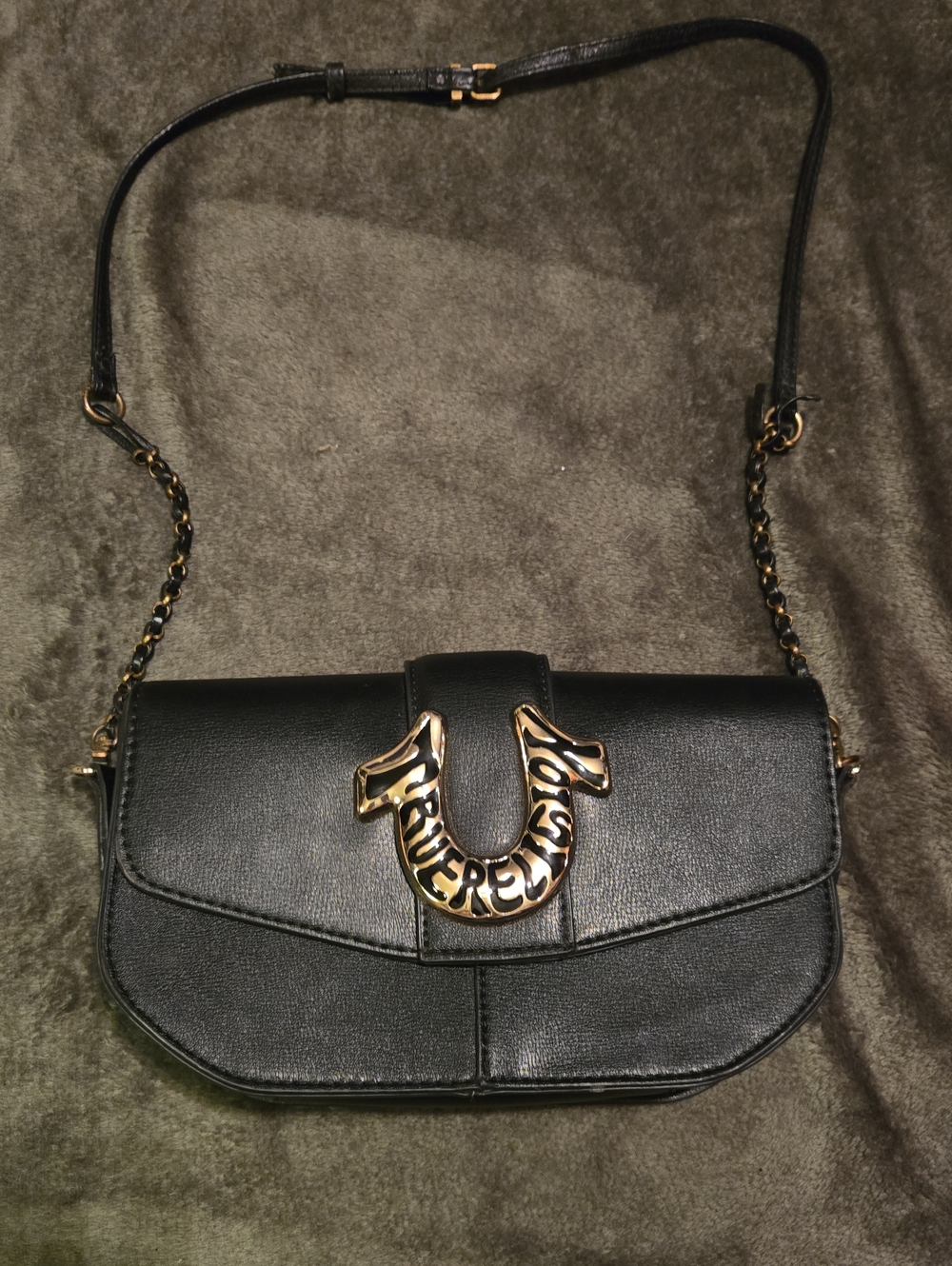 True Religion Black Leather Crossbody Bag with Gold Horseshoe Accent.